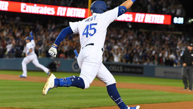 Jun 21, 2019; Los Angeles, CA, USA; Los Angeles Dodgers first baseman Matt Beaty (45) rounds the bases after hitting a walk off two run home run scoring second baseman Max Muncy (13) to defeat the Colorado Rockies 4-2 in the ninth inning at Dodger Stadium. Mandatory Credit: Jayne Kamin-Oncea-USA TODAY Sports